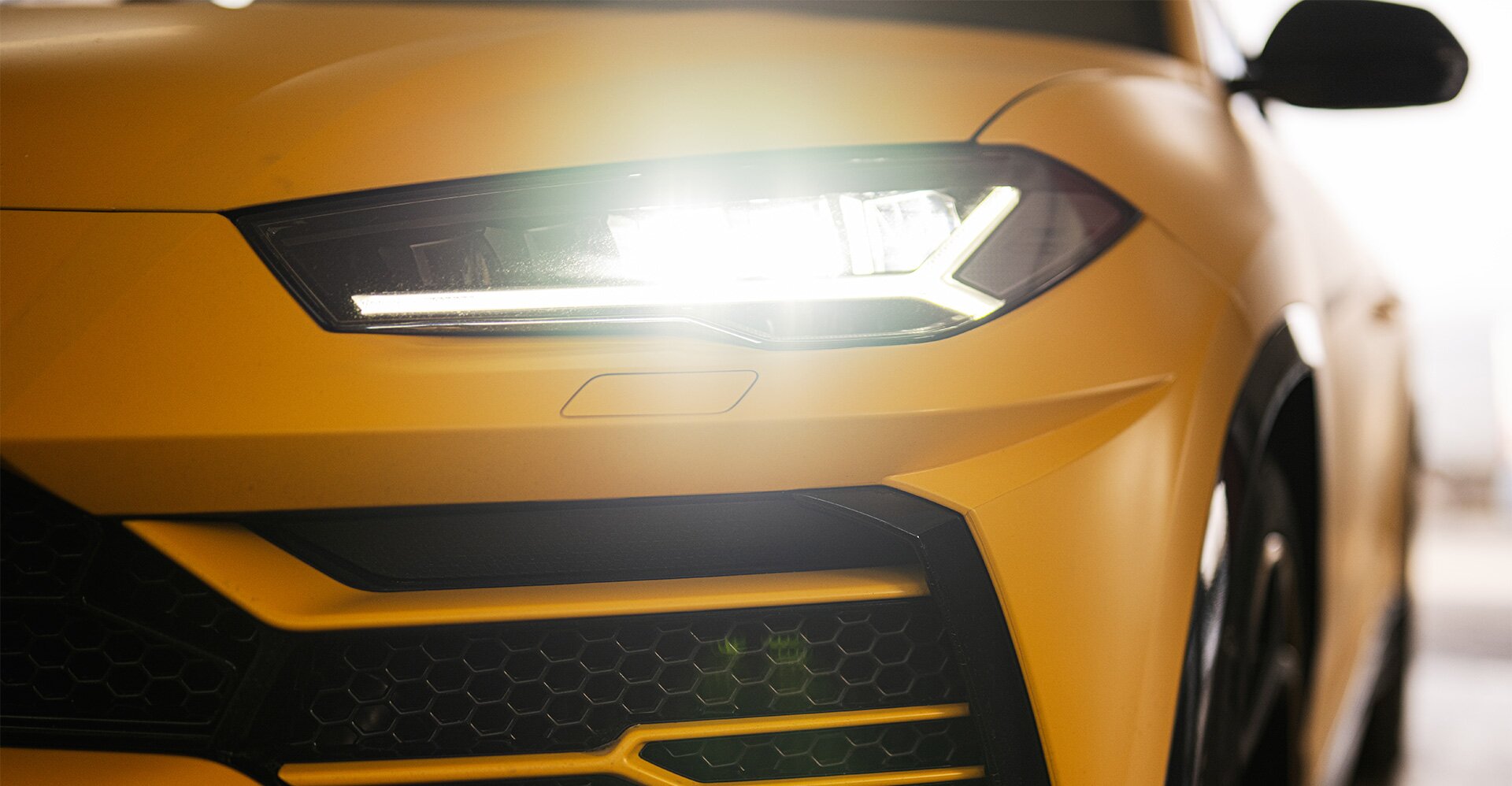 Headlights of yellow sport car suv