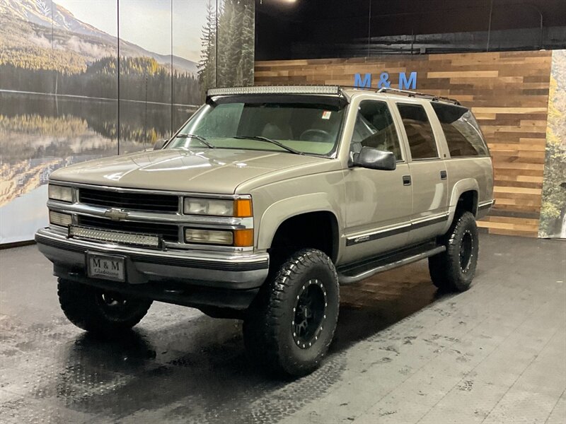 1999 Chevrolet Suburban K1500 LT 4x4 / 5.7L V8 / Leather / LIFTED LIFTED  BF GOODRICH TIRES / LOCAL SUV / RUST FREE / SHARP & CLEAN !! - Photo 1 - Gladstone, OR 97027