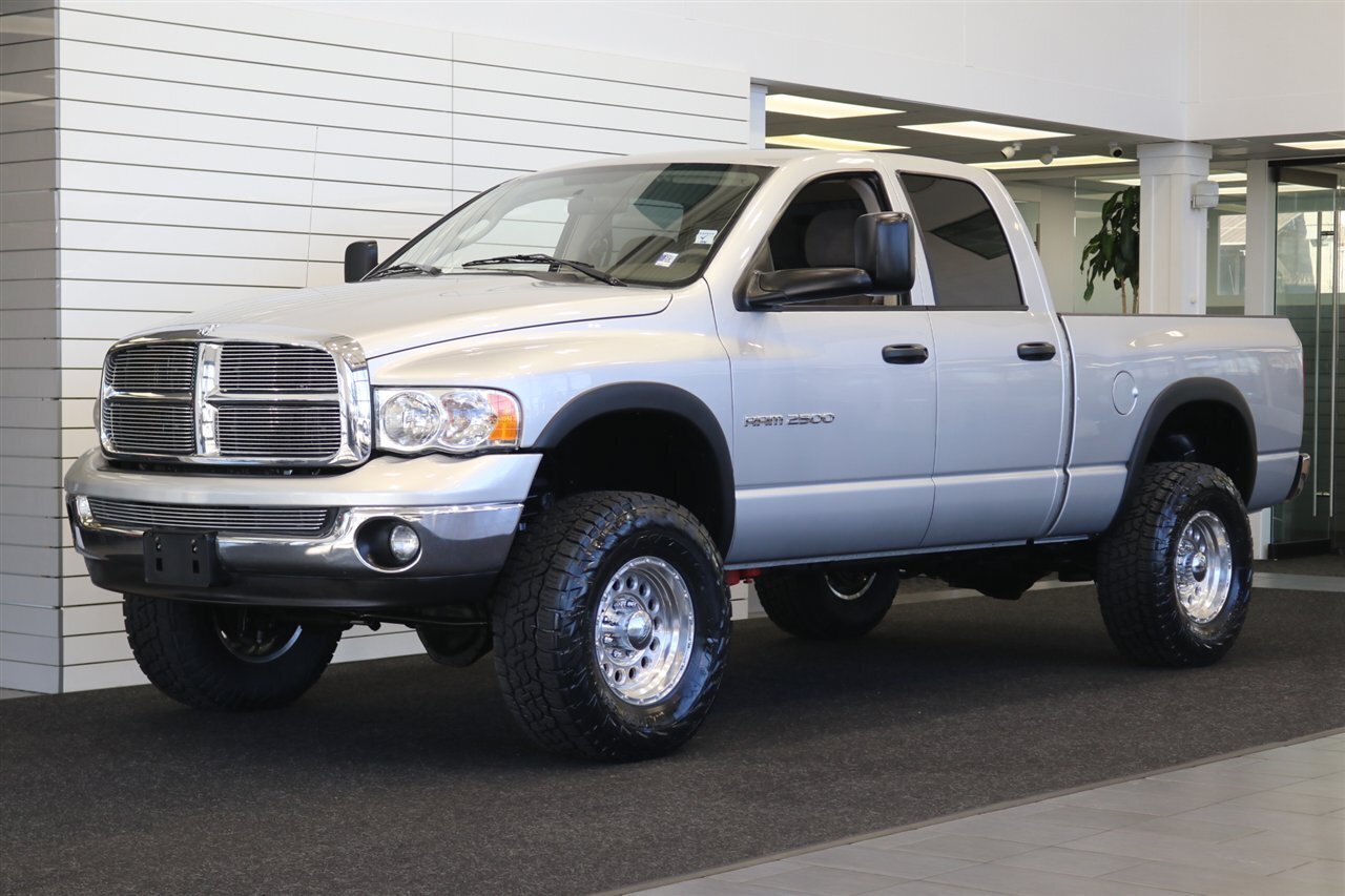 2004 Dodge Ram 2500 SLT 4dr Quad Cab SLT  1-OWNER* 6-SPEED MANUAL* 5.9L HIGH OUTPUT* NEW 3 "BILSTEIN LEVEL KIT* BILSTEIN 5100 SHOCKS* NEW 35 " NITTO G3 10-PLYs* REAR AIR BAGS* SPRAY IN BED LINER* AFE COLD AIR INTAKE - Photo 1 - Portland, OR 97230